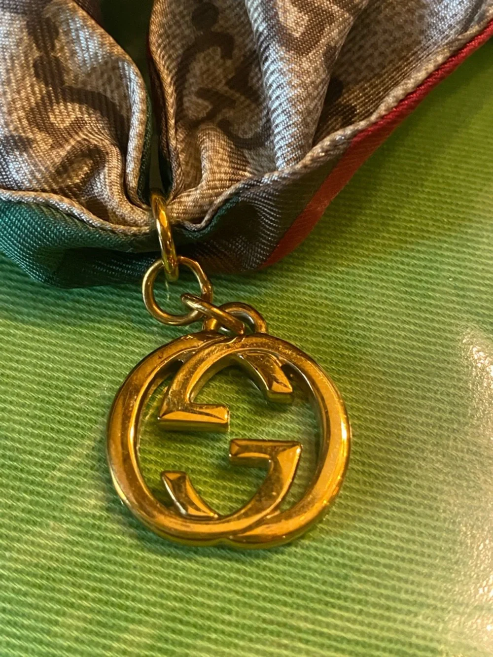 Gucci beige brown GG monogram silk twilly with red trim and gold charm with box